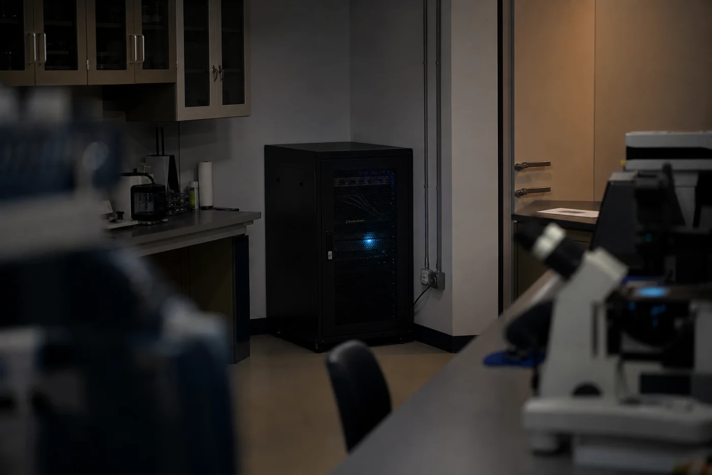 Small server cabinet installed in a laboratory workspace.